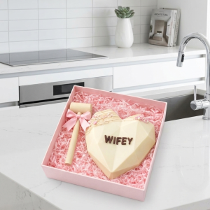 Home Personalized white chocolate smash heart with wifey lettering and wooden mallet in pink gift box.